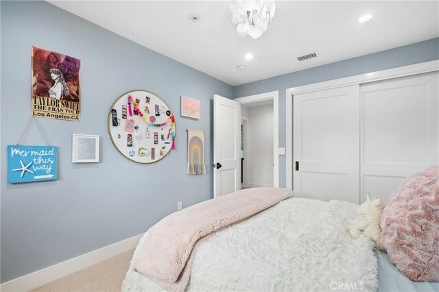 carpeted bedroom with baseboards, a closet, and recessed lighting