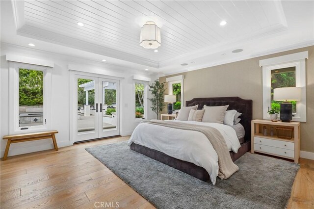 bedroom featuring a raised ceiling, multiple windows, access to outside, wood ceiling, and ornamental molding