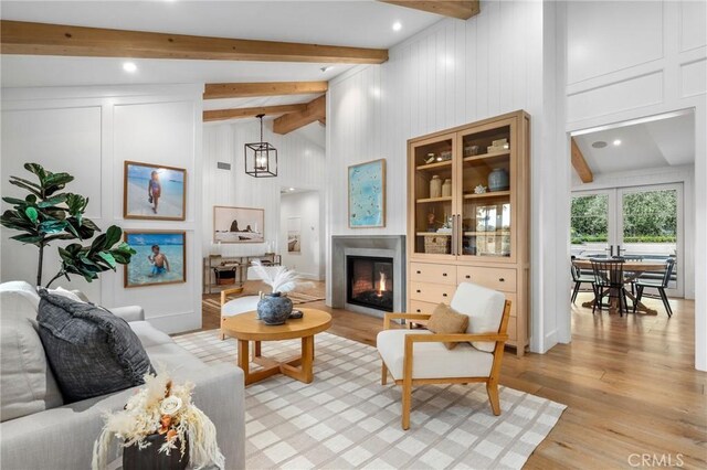 living area featuring a glass covered fireplace and light wood-type flooring