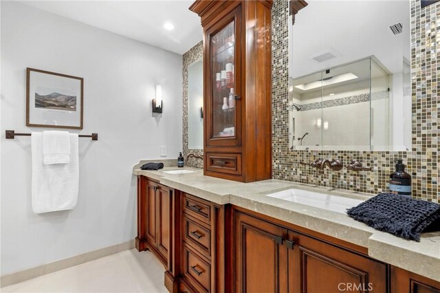 full bathroom featuring tasteful backsplash, a stall shower, double vanity, tile patterned flooring, and recessed lighting