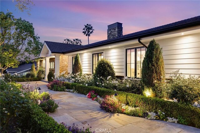 ranch-style house featuring a chimney