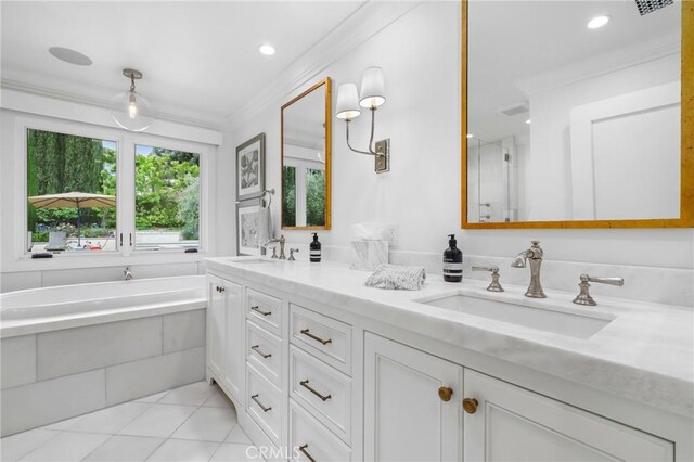 bathroom with ornamental molding, tile patterned floors, double vanity, a bath, and recessed lighting