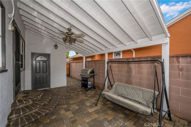 view of patio / terrace with grilling area, fence, and a ceiling fan