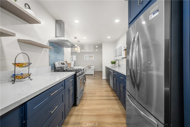 kitchen featuring stainless steel appliances, blue cabinets, range hood, open shelves, and light wood-style floors