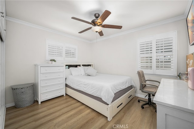 bedroom with light wood finished floors, crown molding, baseboards, ceiling fan, and a desk