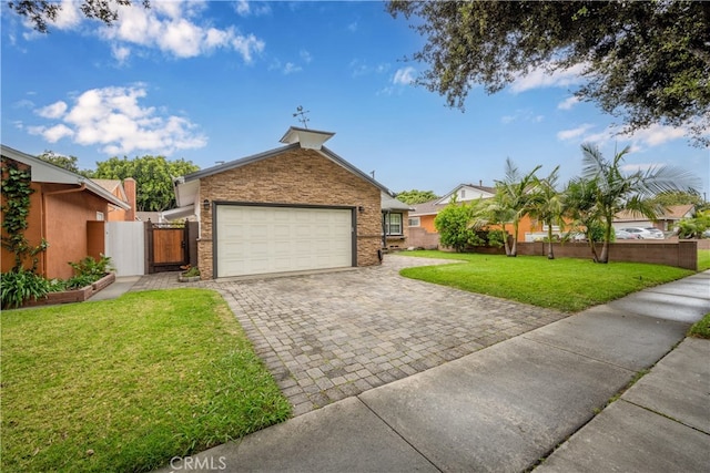 view of front of property with an attached garage, decorative driveway, a gate, and brick siding