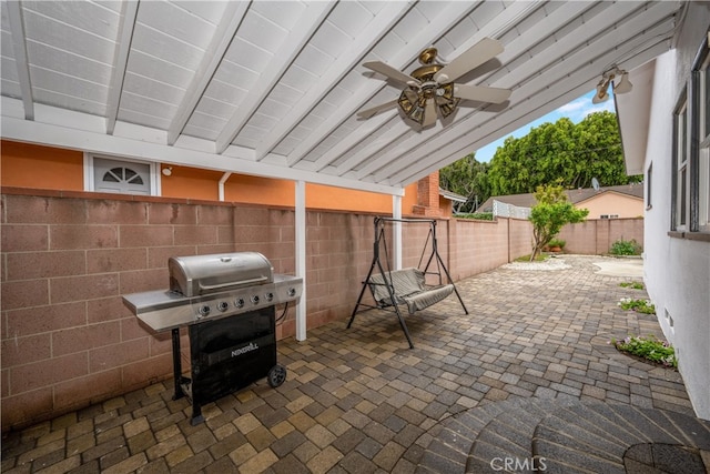 view of patio with a fenced backyard, a grill, and a ceiling fan