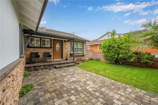 rear view of house featuring a patio area and a shingled roof