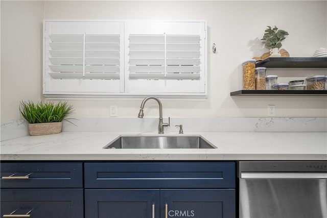 kitchen featuring stainless steel dishwasher, a sink, open shelves, and blue cabinets