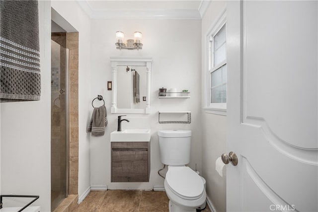 bathroom featuring crown molding, toilet, a tile shower, vanity, and a chandelier