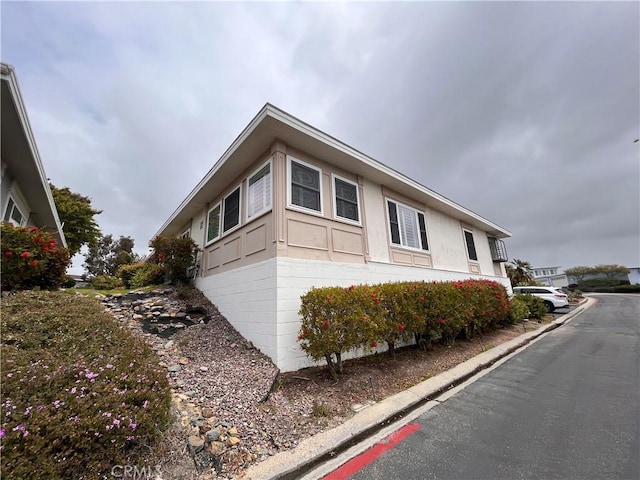view of side of property with stucco siding