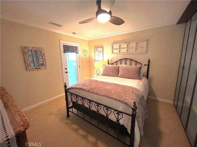 bedroom featuring light carpet, baseboards, crown molding, and a ceiling fan