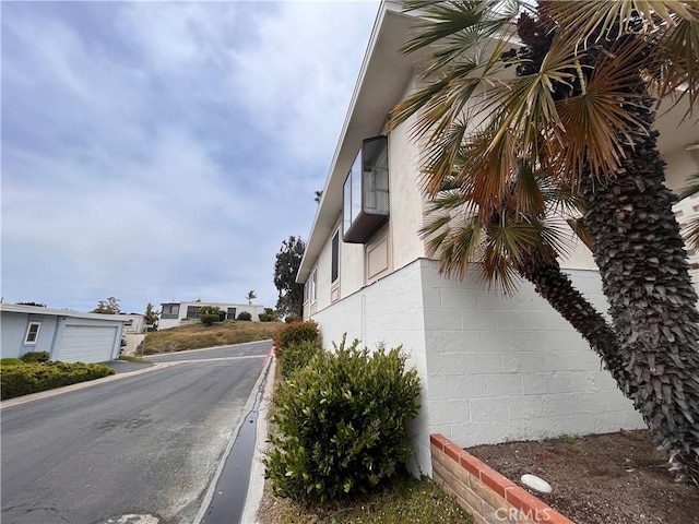 view of property exterior with concrete block siding