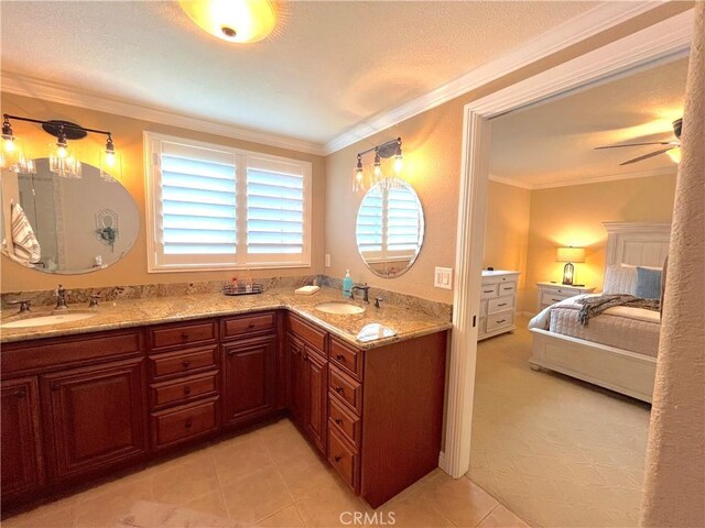 bathroom with ensuite bathroom, double vanity, crown molding, tile patterned flooring, and ceiling fan