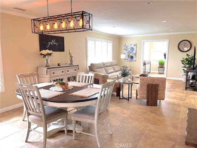 dining room featuring ornamental molding, light tile patterned floors, and baseboards