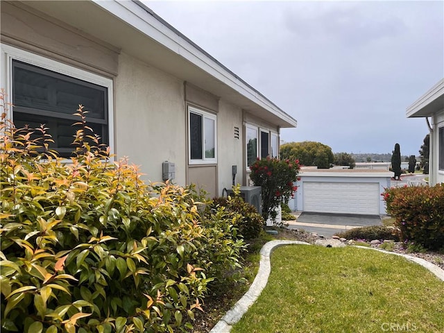 3747 Vista Campana S Unit 7, Oceanside, CA 92057 - view of side of property featuring stucco siding, a yard, and central AC