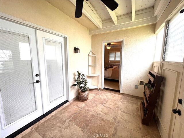 doorway to property featuring a ceiling fan and a patio area