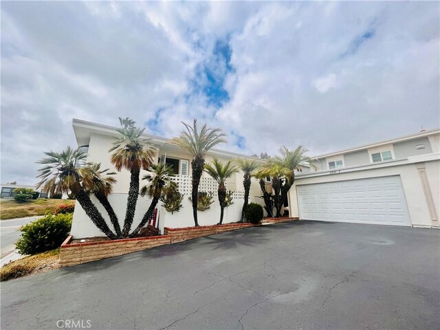 3747 Vista Campana S Unit 7, Oceanside, CA 92057 - view of front of property with asphalt driveway, stucco siding, and an attached garage