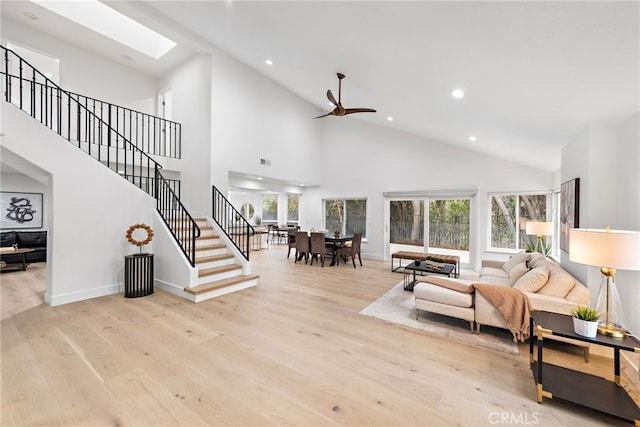 24572 Wembley Cir, Laguna Hills, CA 92653 - living area with high vaulted ceiling, wood finished floors, healthy amount of natural light, stairs, and a skylight