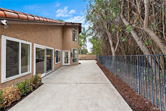 24572 Wembley Cir, Laguna Hills, CA 92653 - view of home's exterior with a fenced backyard, a patio, and stucco siding