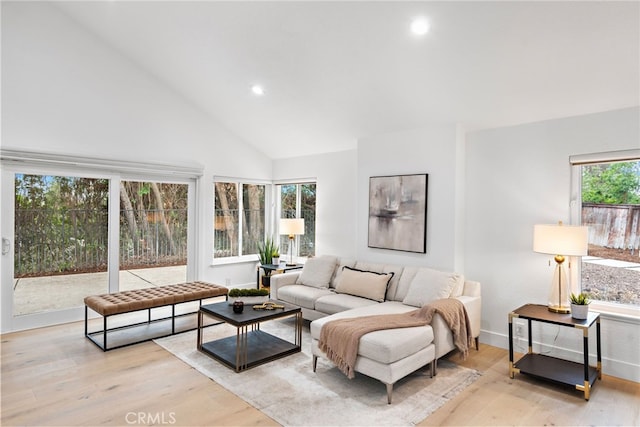 24572 Wembley Cir, Laguna Hills, CA 92653 - living room featuring light wood-type flooring, recessed lighting, high vaulted ceiling, and baseboards