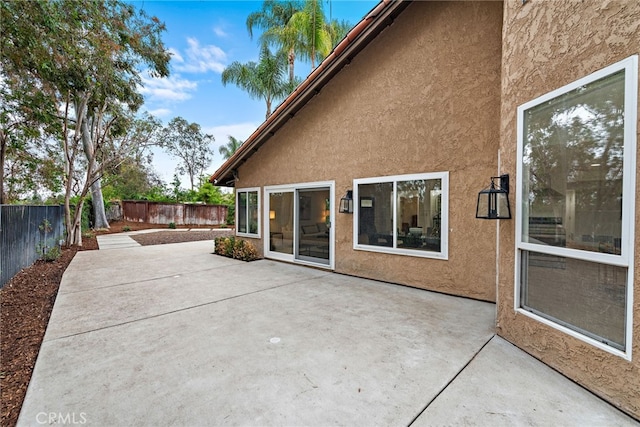 24572 Wembley Cir, Laguna Hills, CA 92653 - back of property featuring stucco siding, a fenced backyard, and a patio