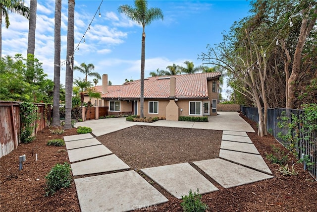 24572 Wembley Cir, Laguna Hills, CA 92653 - view of front of house featuring a tile roof, stucco siding, a patio, and a fenced backyard