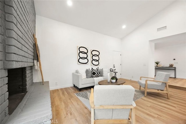4592 Paloma Ln, Yorba Linda, CA 92886 - living room with high vaulted ceiling, a brick fireplace, light wood-style floors, baseboards, and recessed lighting