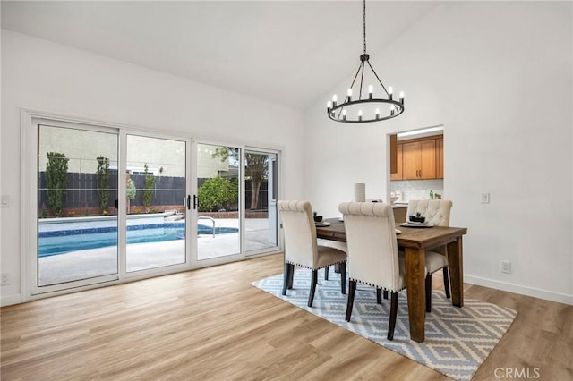 4592 Paloma Ln, Yorba Linda, CA 92886 - dining room featuring a chandelier, high vaulted ceiling, light wood-style flooring, and baseboards