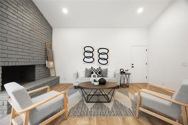 4592 Paloma Ln, Yorba Linda, CA 92886 - living area with lofted ceiling, a brick fireplace, wood finished floors, and recessed lighting