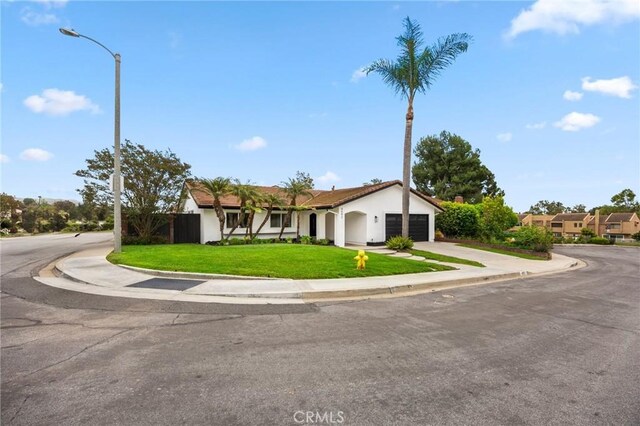 4592 Paloma Ln, Yorba Linda, CA 92886 - view of front facade with an attached garage, a front lawn, concrete driveway, and stucco siding