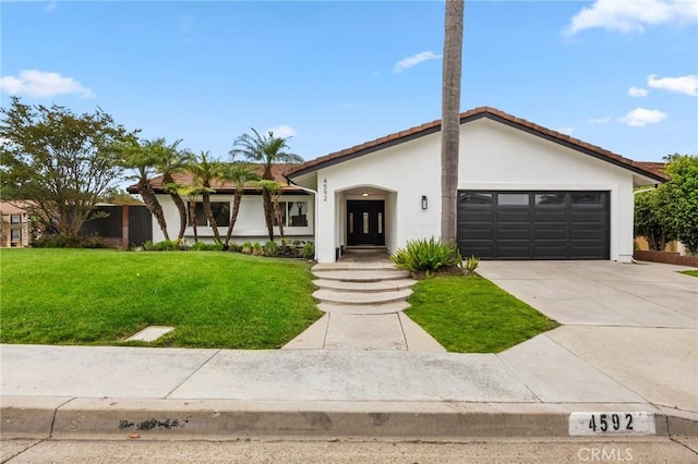 4592 Paloma Ln, Yorba Linda, CA 92886 - view of front of house with driveway, an attached garage, a front lawn, stucco siding, and a tile roof