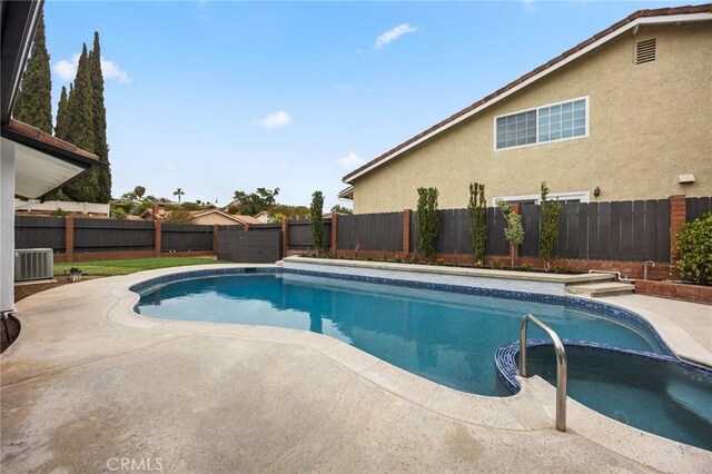 4592 Paloma Ln, Yorba Linda, CA 92886 - view of swimming pool featuring a fenced backyard, a patio area, a pool with connected hot tub, and central AC unit