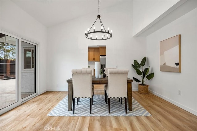 4592 Paloma Ln, Yorba Linda, CA 92886 - dining area featuring a chandelier, light wood-style floors, baseboards, and a high ceiling