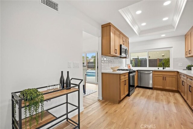 4592 Paloma Ln, Yorba Linda, CA 92886 - kitchen with stainless steel appliances, light wood-type flooring, backsplash, ornamental molding, and recessed lighting