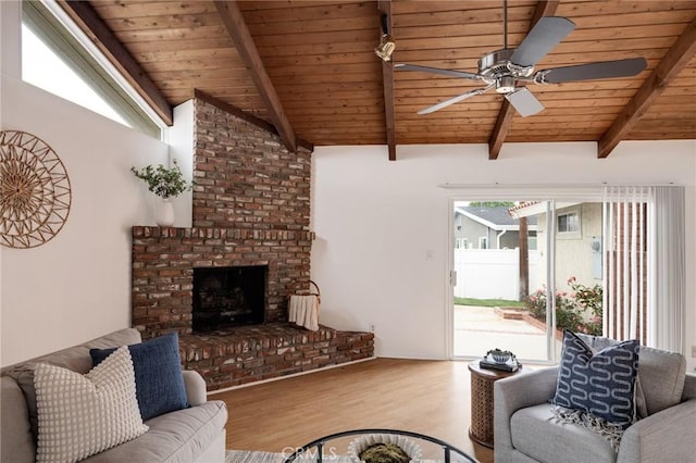 living area featuring wood finished floors, ceiling fan, wood ceiling, and a brick fireplace
