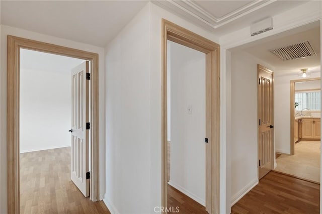 corridor featuring wood finished floors and baseboards