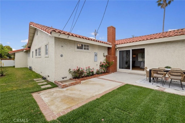 back of property featuring a patio area, stucco siding, a yard, and crawl space