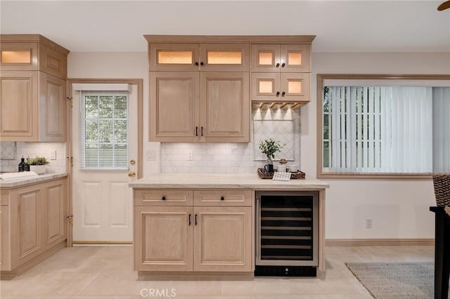 indoor dry bar with beverage cooler, backsplash, and light tile patterned floors