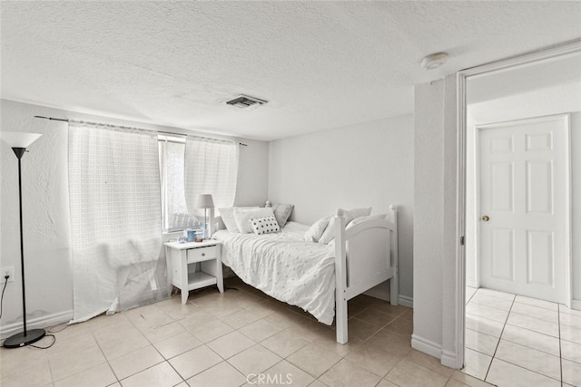 19903 Vanowen St, Winnetka, CA 91306 - bedroom featuring light tile patterned flooring, a textured ceiling, and baseboards