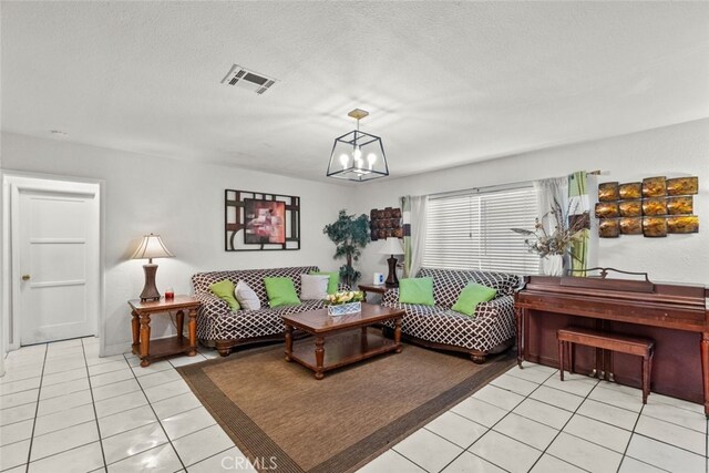 19903 Vanowen St, Winnetka, CA 91306 - living room with a chandelier, light tile patterned flooring, and a textured ceiling