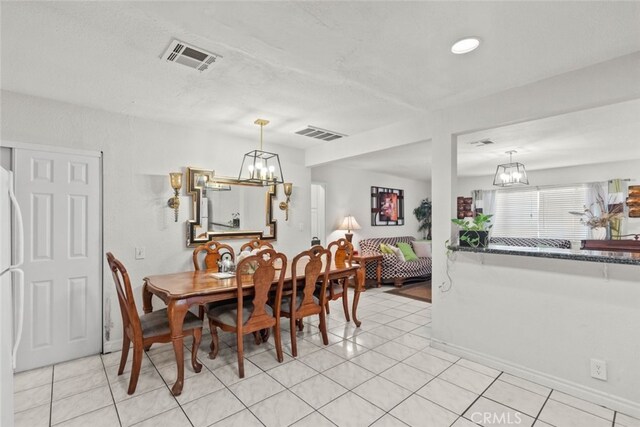 19903 Vanowen St, Winnetka, CA 91306 - dining room featuring a chandelier, light tile patterned floors, and baseboards