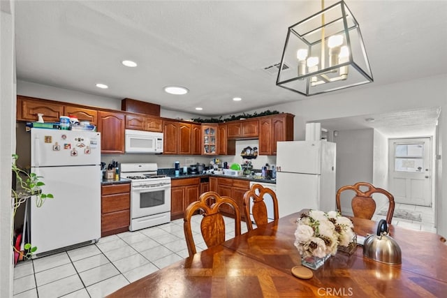 19903 Vanowen St, Winnetka, CA 91306 - kitchen with white appliances, light tile patterned flooring, dark countertops, glass insert cabinets, and brown cabinetry