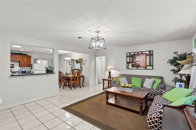 19903 Vanowen St, Winnetka, CA 91306 - living room with a chandelier, light tile patterned floors, and baseboards