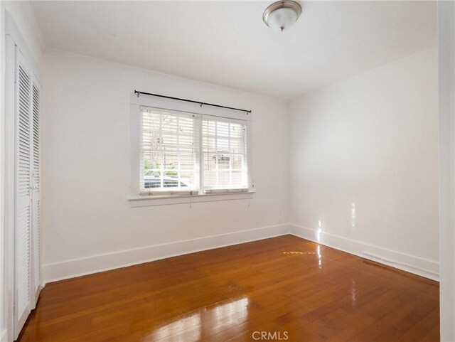 1122 Loma Dr, Hermosa Beach, CA 90254 - unfurnished bedroom featuring hardwood / wood-style floors, a closet, baseboards, and ornamental molding