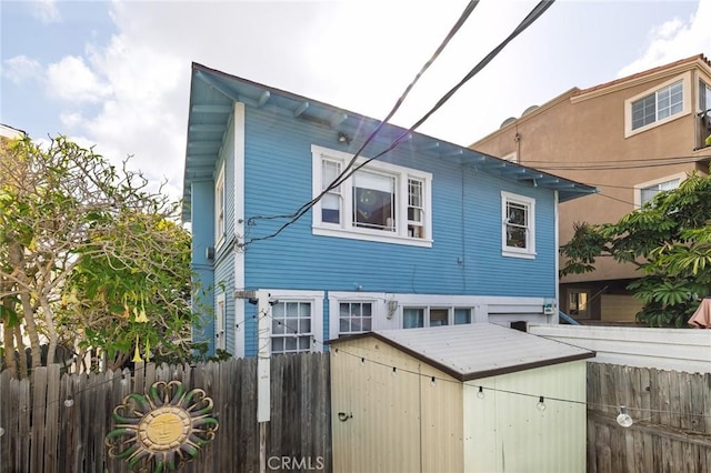 1122 Loma Dr, Hermosa Beach, CA 90254 - rear view of house with a storage unit, a fenced backyard, and an outdoor structure