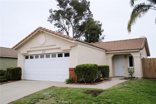 27798 Cloud Dance Ct, Menifee, CA 92585 - mediterranean / spanish home featuring an attached garage, driveway, stucco siding, and a tile roof