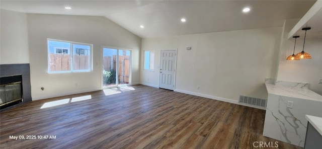 27798 Cloud Dance Ct, Menifee, CA 92585 - unfurnished living room with dark wood finished floors, lofted ceiling, a glass covered fireplace, recessed lighting, and baseboards