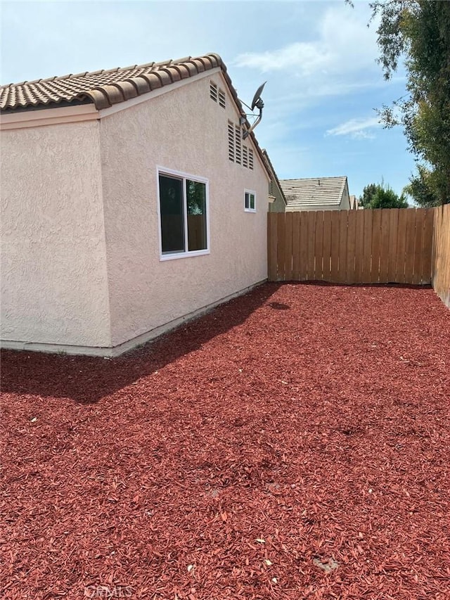 27798 Cloud Dance Ct, Menifee, CA 92585 - view of side of property featuring stucco siding and a tile roof