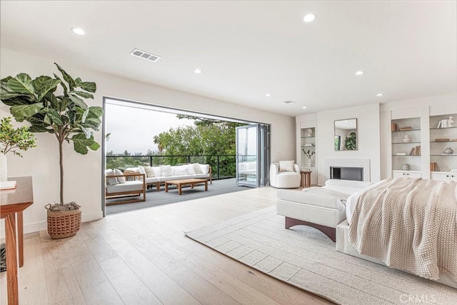 18101 Green Meadow Dr, Encino, CA 91316 - living room with recessed lighting, wood finished floors, built in shelves, and a fireplace